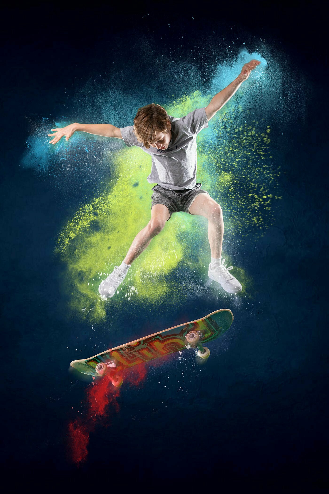 Boy on skateboard jumping in mid-air with dust and powder flying off for a digital art composite